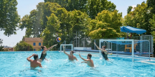 un groupe de personnes jouant au volley-ball dans une piscine